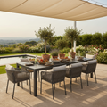 Large slate top outdoor dining table styled on a luxury garden terrace