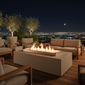 Cast concrete fire pit with flames on a luxury outdoor terrace at night